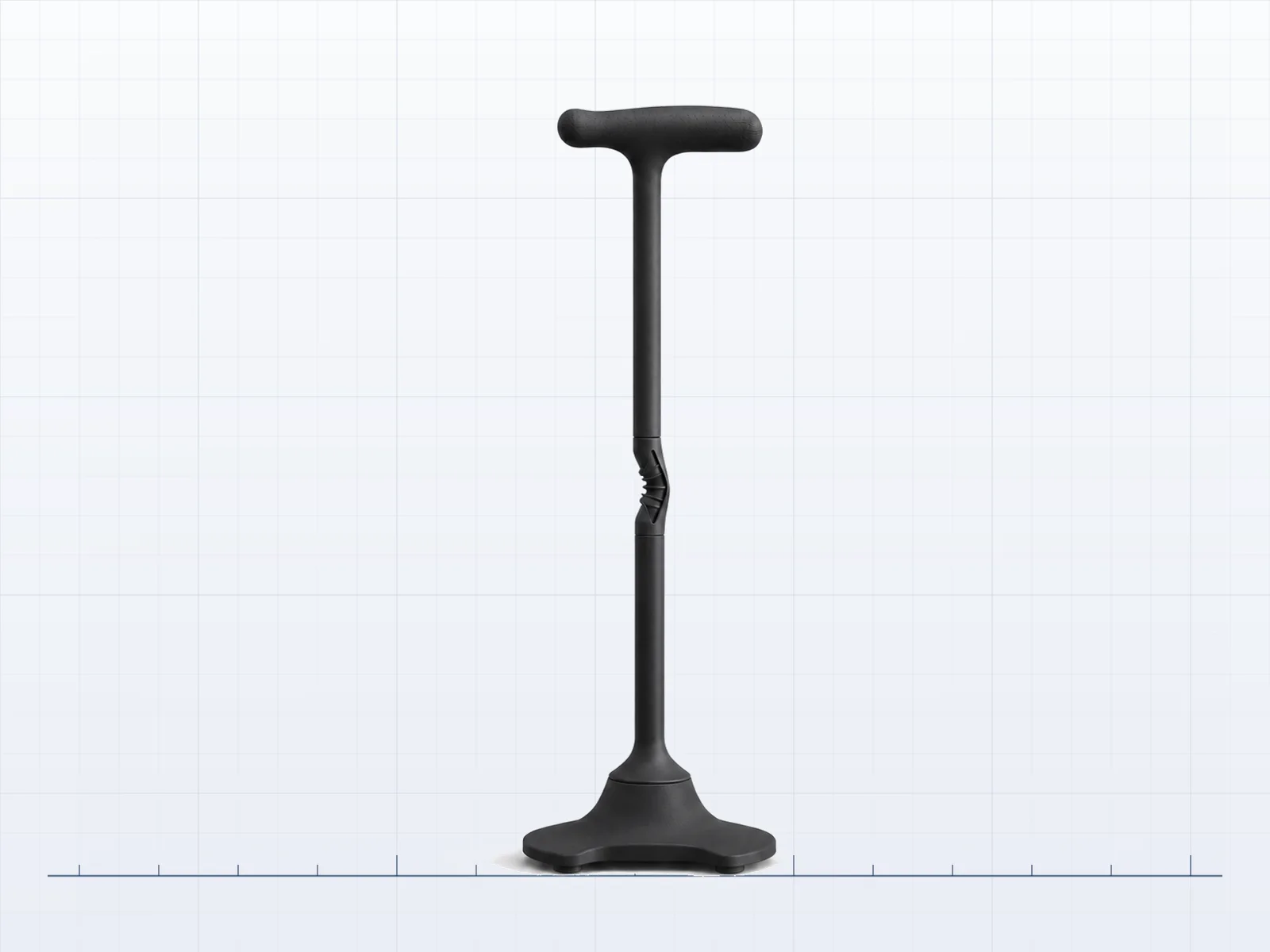 Study plate: the support object in a near-black graphite finish with a ribbed grip, standing on a baseline rule over a fine measurement grid.